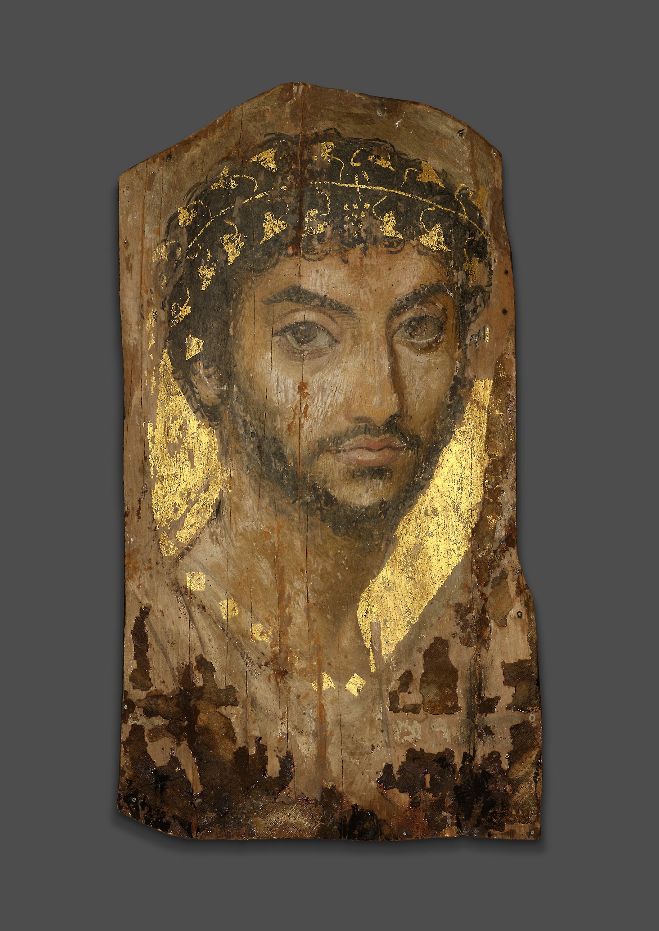 Mummy Portrait of a Man Wearing an Ivy Wreath by Unknown Artist - 101 CE–150 CE - 39.4 × 22 × 0.2 cm Art Institute of Chicago